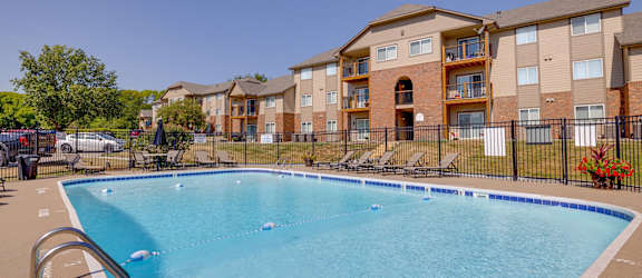 Community pool at Regency Woods Apartments, surrounded by a relaxing poolside area.