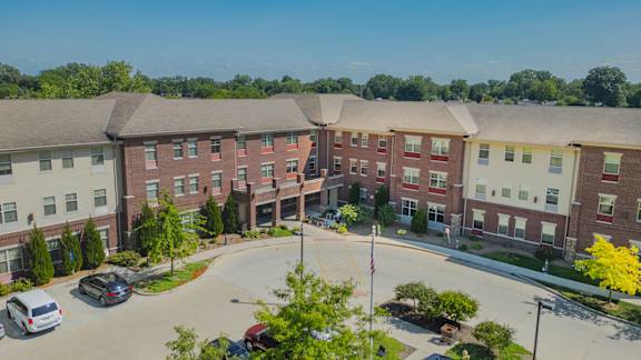 The Commons at Garden Lake is a large, multi-story building with a grassy front yard.