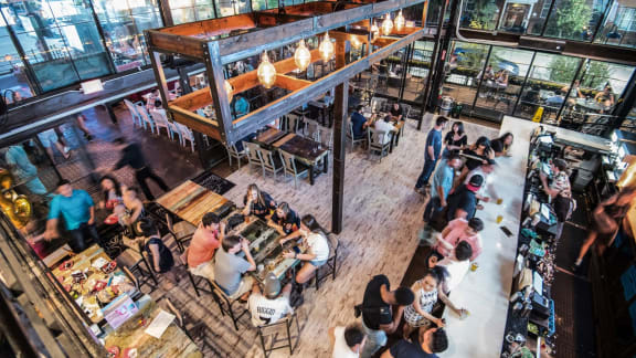 a large group of people sitting at tables in a restaurant