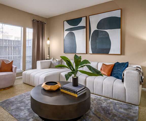 a living room with a white couch and a coffee table