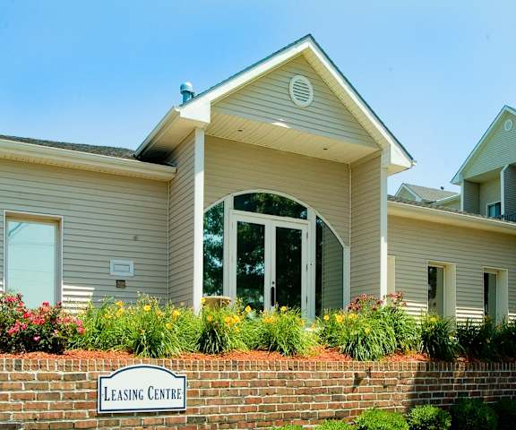 a house with a sign for leasing center in front of it