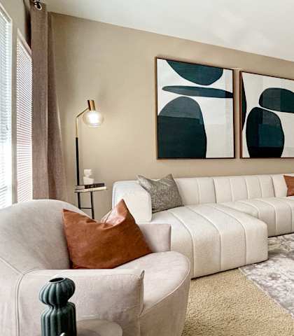 a living room with a white couch and a fireplace