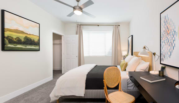 a bedroom with a bed and desk in a 555 waverly unit