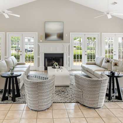 A living room with a fireplace and a television at The Colony Apartment Homes, Mississippi