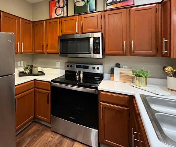 a kitchen with stainless steel appliances and wooden cabinets