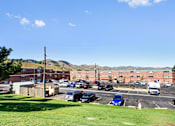 Thumbnail 4 of 12 - Parking lot view at Golden Arms Apartments, Golden