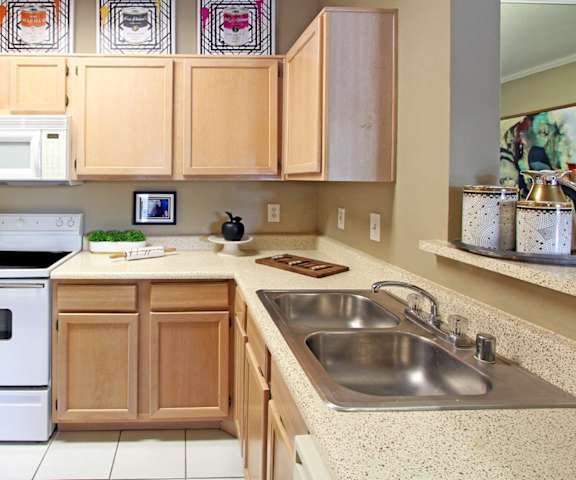 a kitchen with white appliances and wooden cabinets