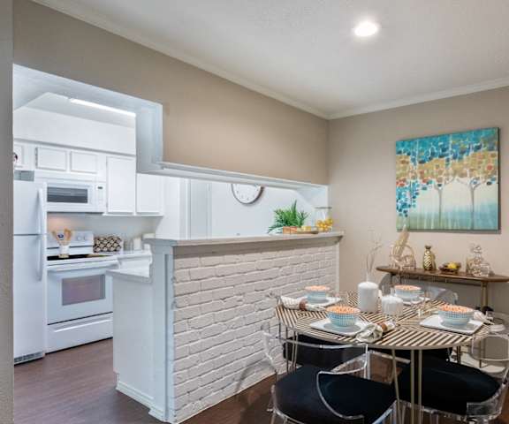 an open kitchen and dining room with a table and chairs