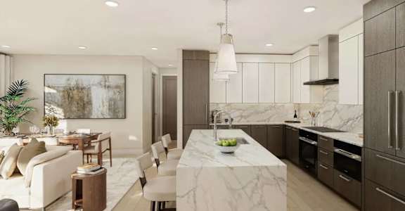 A modern kitchen with a marble countertop and a dining area with a white sofa and chairs.