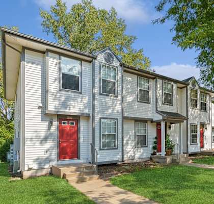 a row of white houses with a red door at Mason Street Townhomes, Grand Rapids, Michigan