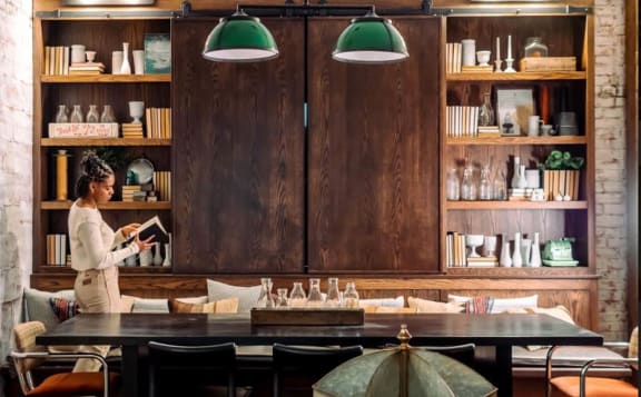 a woman standing behind a table in a restaurant