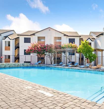 a swimming pool in front of an apartment building