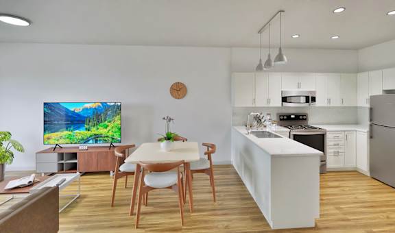 A modern kitchen with a dining table and chairs.