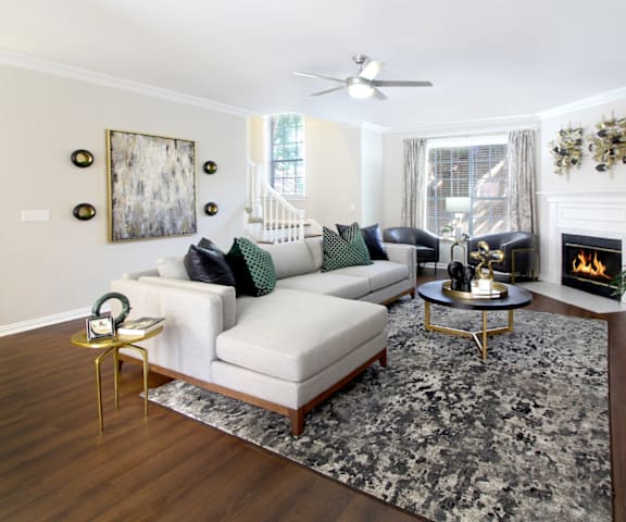 a living room with a couch and a rug and a fireplace