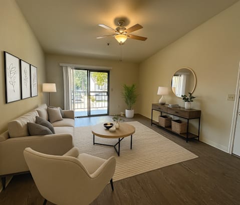 A living room with a couch, chairs, and a coffee table.