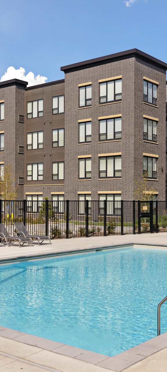 A large building with a pool in front.