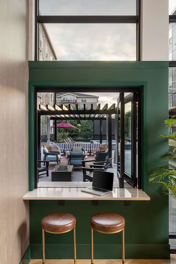 a rendering of a lobby with chairs and tables and a checkered floor