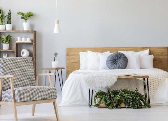 a bedroom with a bed and plants in it