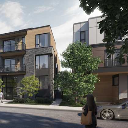 A modern apartment building with balconies and trees in front.