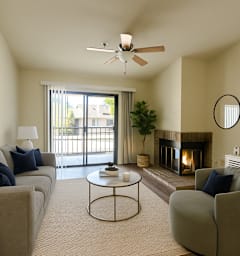 A living room with a grey couch, a coffee table, a fireplace, and a television.