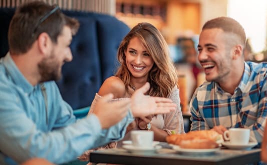 group of people sitting at a table in a restaurant