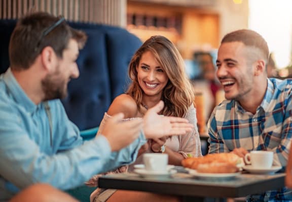 group of people sitting at a table in a restaurant