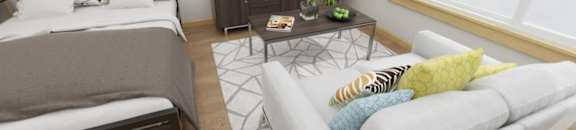 A living room with a grey couch, a bed, a coffee table, and a television.