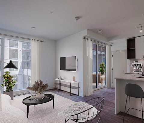 A modern living room with a black coffee table and grey chairs.