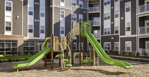 a playground at an apartment complex with slides