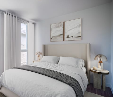 A bedroom with a large bed and a view of a balcony outside.