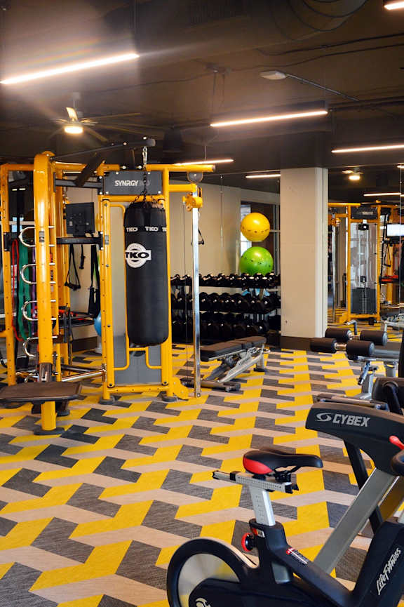 A gym with a variety of equipment including a stationary bike. at Encore at Forest Park Apartments, Saint Louis, MO, 63110