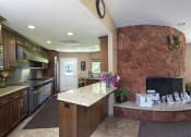 Thumbnail 8 of 33 - View of community clubhouse kitchen and fireplace