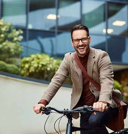 a man riding a bike in front of a building