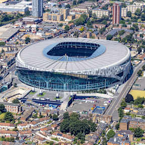 Aerial view of Tottenham Hotspur Stadium and surrounding neighbourhood.