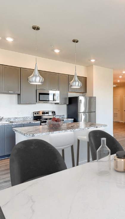 an open kitchen and dining area with a white table and chairs