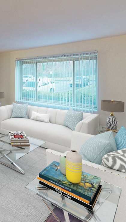 a living room with a white couch and a glass table