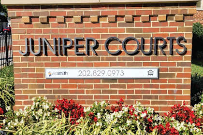 a brick wall with a sign that reads jupiter courts