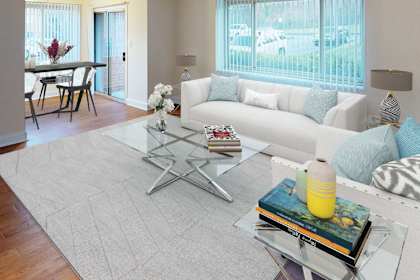 a living room with a white couch and a glass table