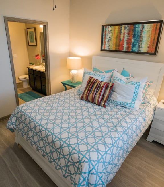 a bedroom with a bed and a bathroom