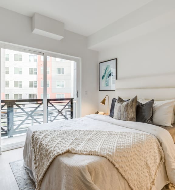 a bedroom with a bed and a sliding glass door to a balcony at Rialto, Washington, 20002