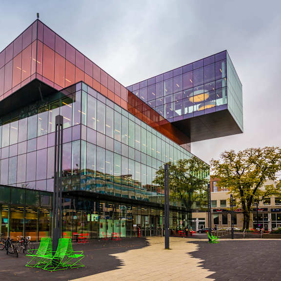 A modern building with a glass facade and a triangular design.