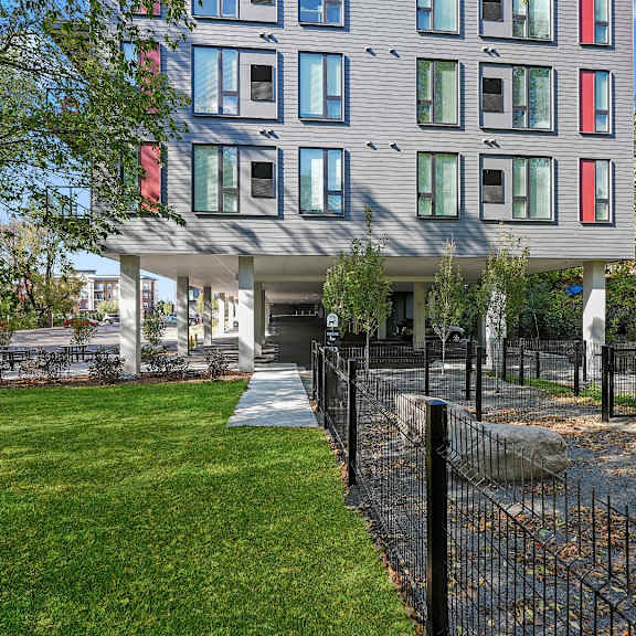 A modern building with a black fence in front.
