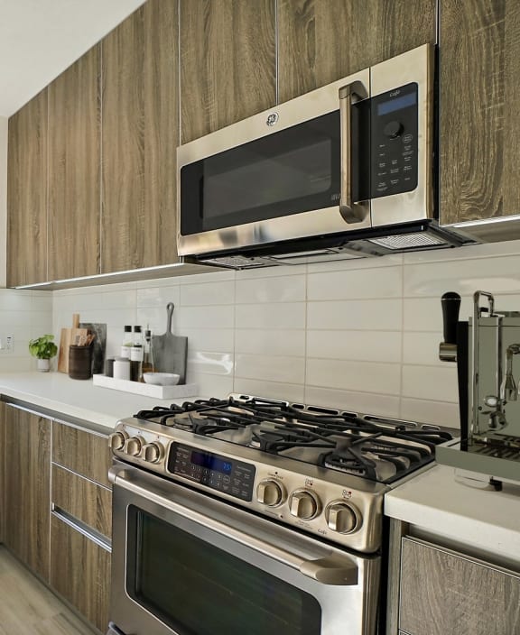 a kitchen with stainless steel appliances and wooden cabinets