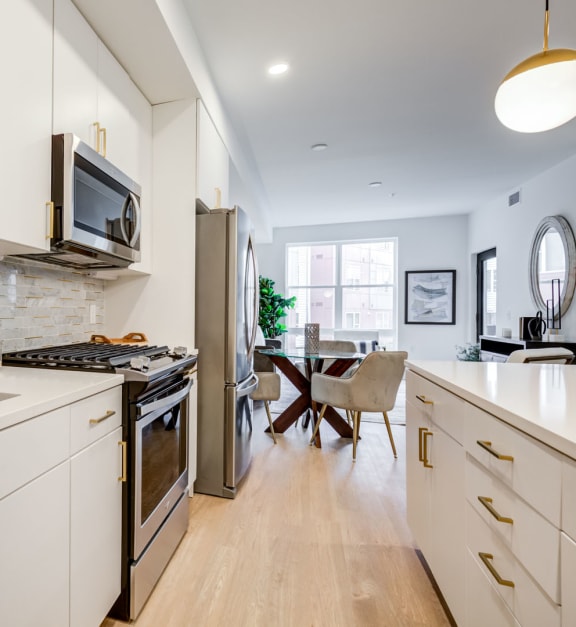 a kitchen with a sink and a stove and a microwave at Rialto, Washington, DC