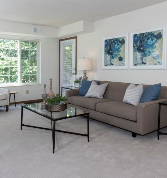 a living room with a couch and two tables