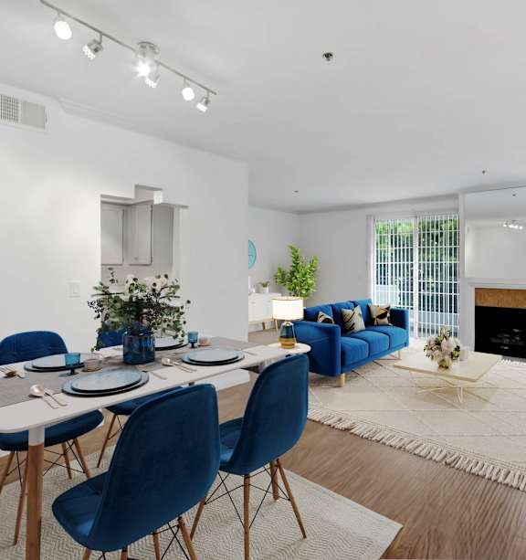 a living room with a dining room table and a fireplace