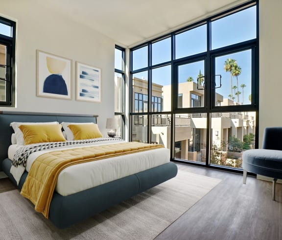 a bedroom with a bed and a large window