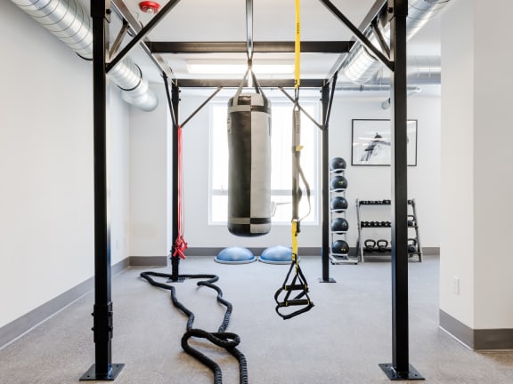 a punching bag hangs from the ceiling in a gym