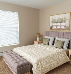 a bedroom with a bed and two nightstands