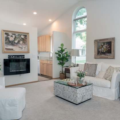 a living room filled with furniture and a large window